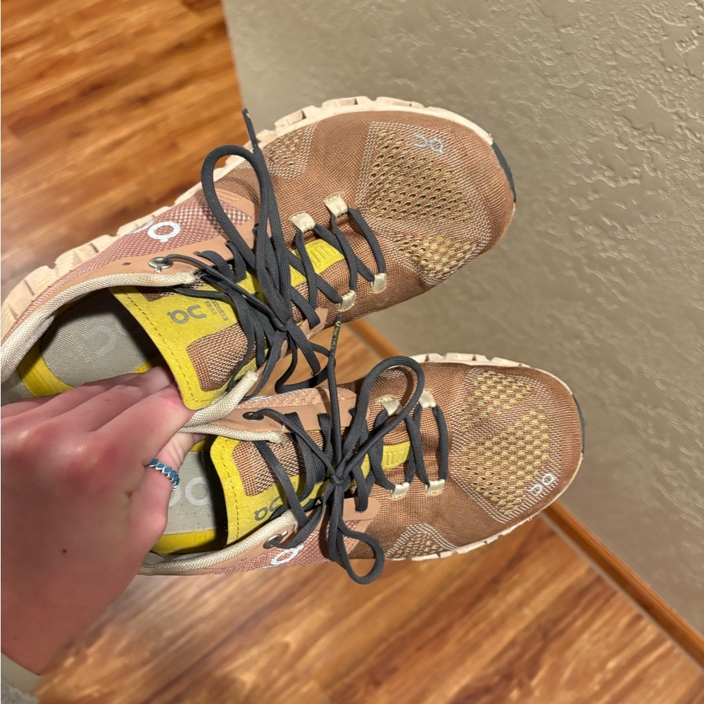 On Running Tan and Black Athletic Shoes